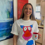 Nazli in a Shmoof T-shirt holding the Shmoof mug